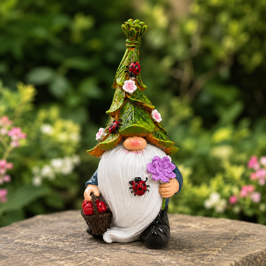 Decoratieve kabouter van hars met bladhoed en rode paddenstoelen